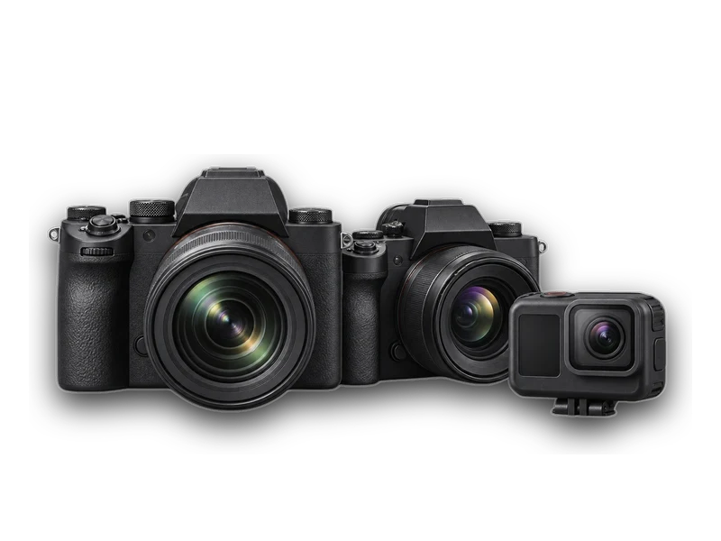 Two mirrorless cameras with lenses and an action camera